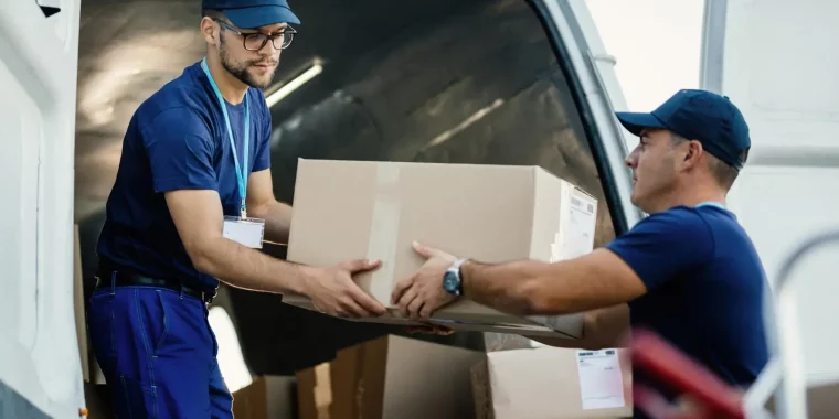 delivery-men-loading-carboard-boxes-van-while-getting-ready-shipment (1)